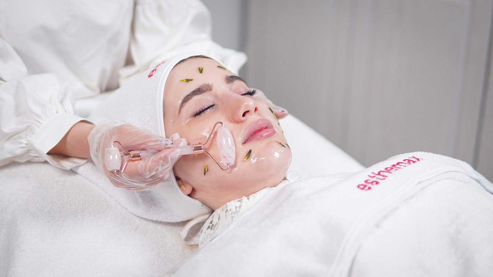 a woman getting a facial mask on her face