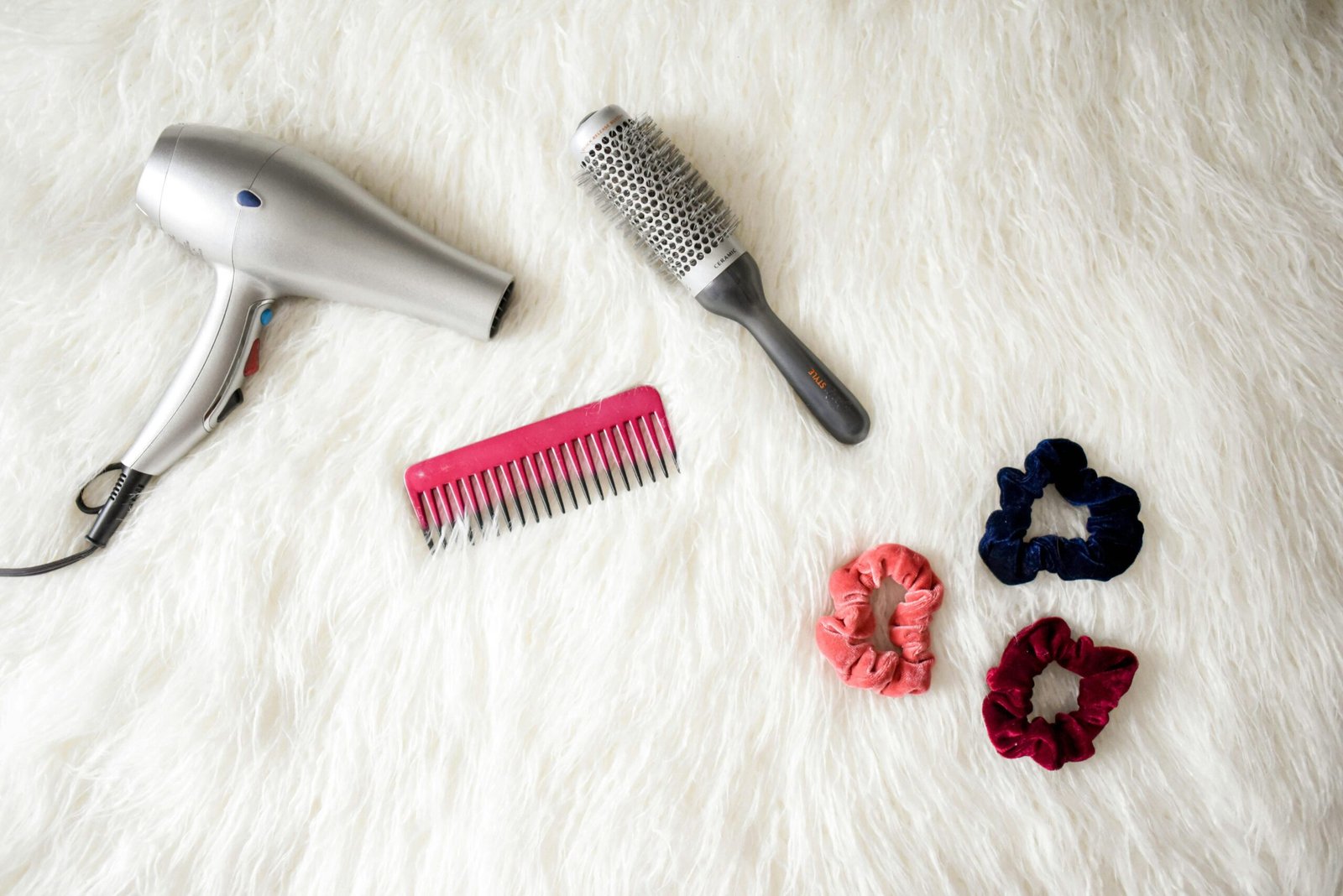 Grey hair blower near pink hair combs and scrunchies