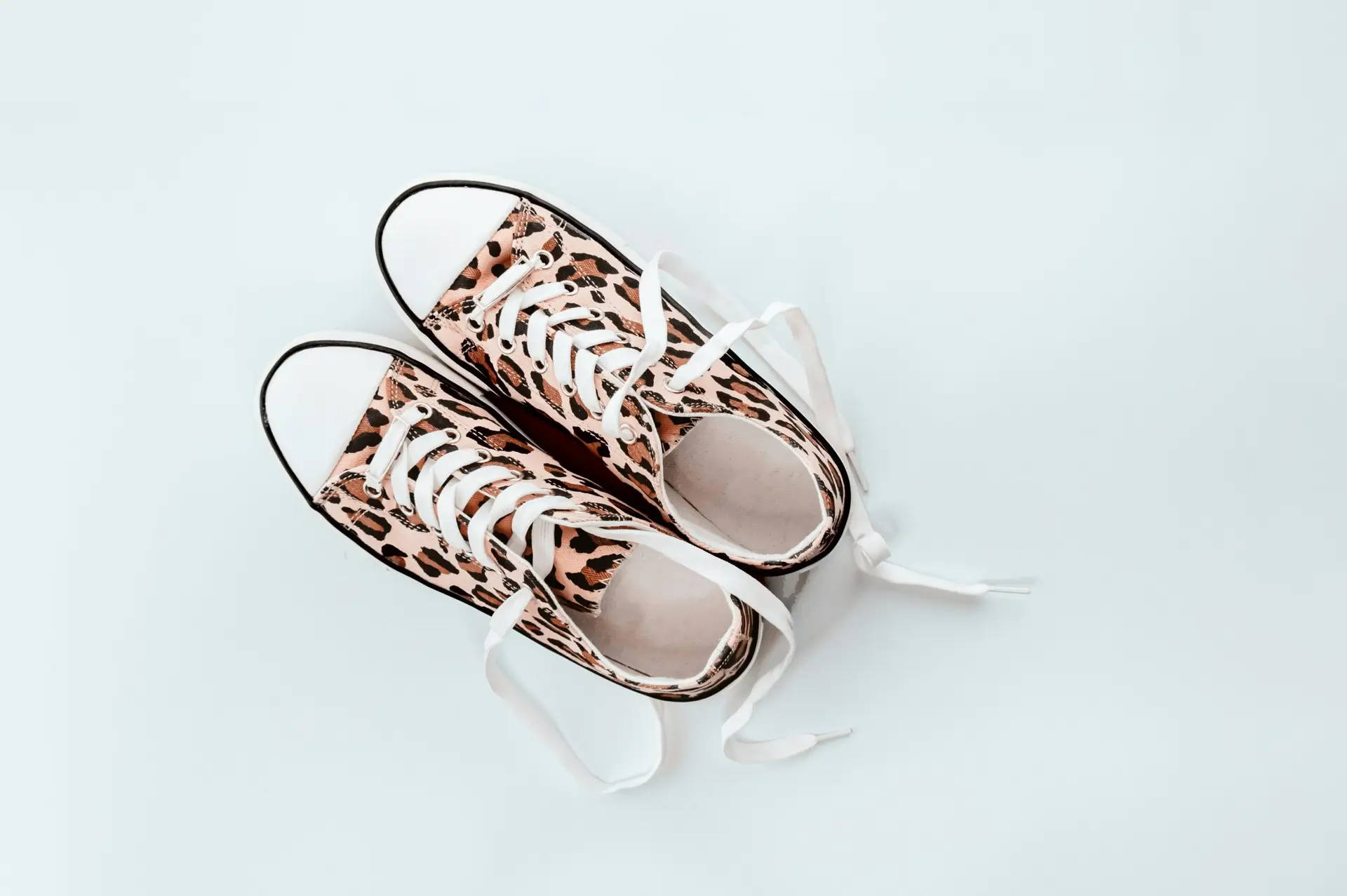 pair of brown-and-beige leopard print low-top sneakers