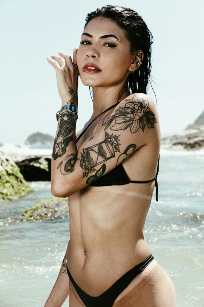 Photo of a woman wearing a bikini with a tattoo on an arm