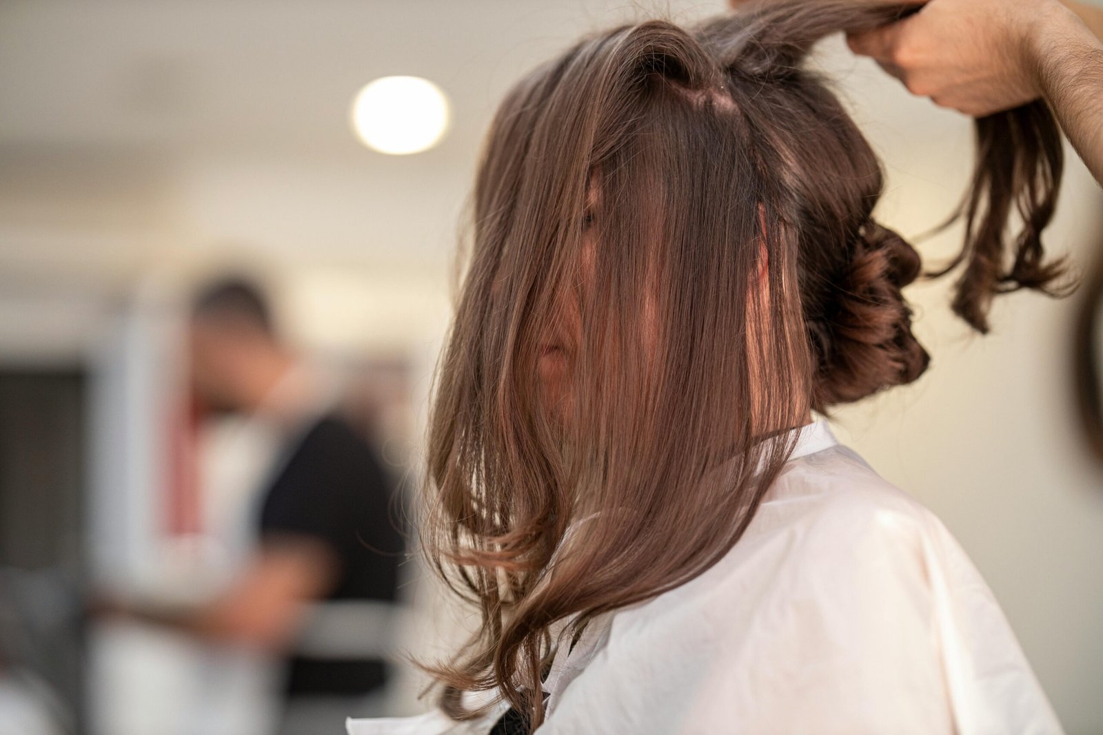 Shallow focus photo of person fixing hair