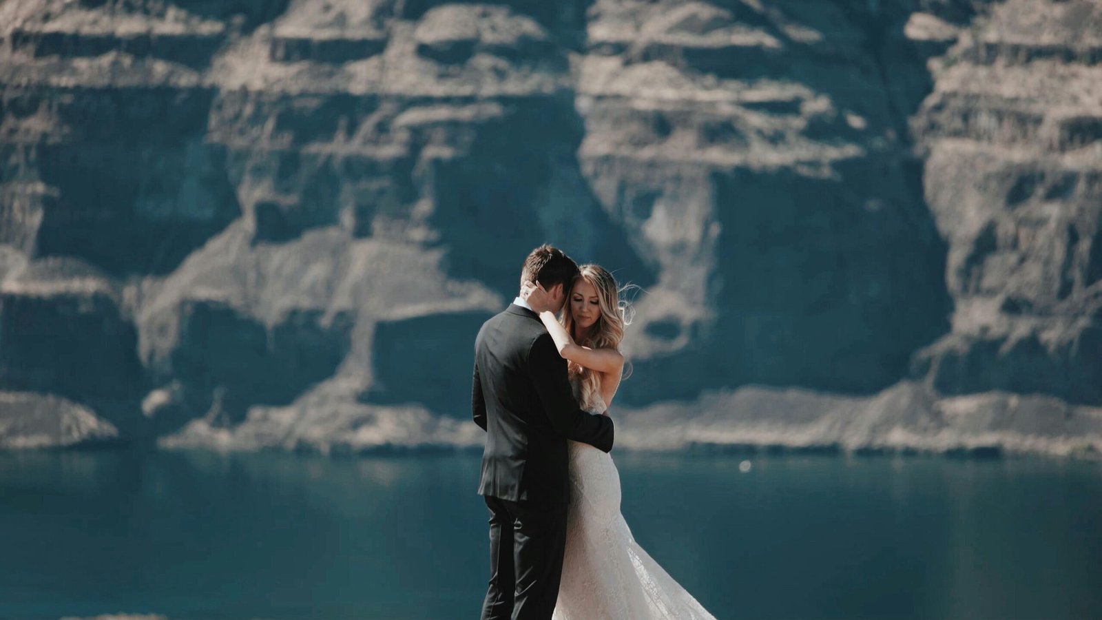 Wedding couple hug on cliff