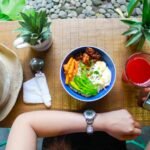 Woman holding iphone while eating