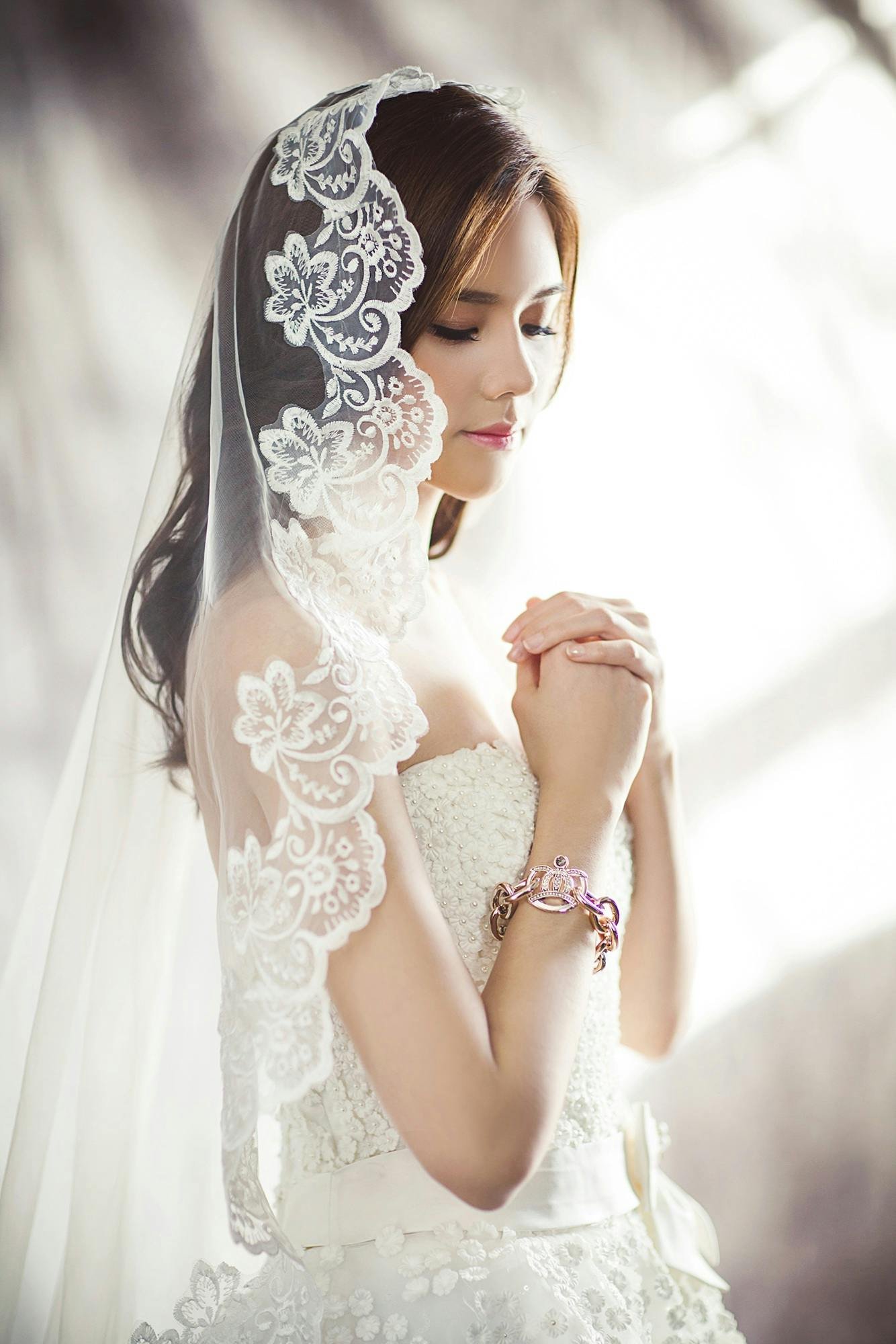 Woman in white bridal gown meditating