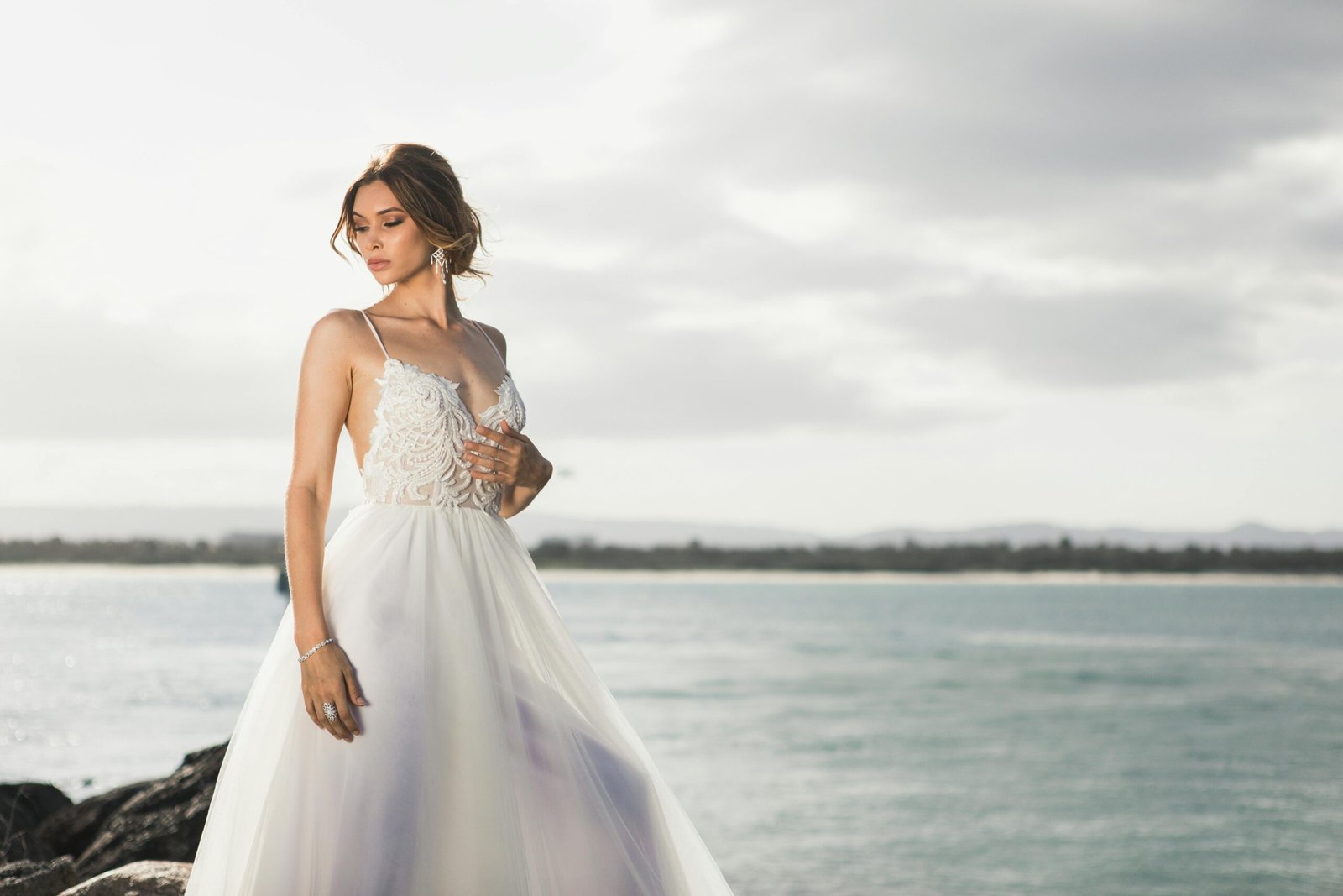 Woman standing beside body of water