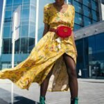 Woman wearing yellow floral v neck long dress and pair of green wedge sandals